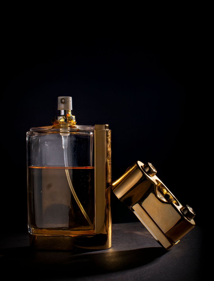 Amber perfume bottle with sculpted gold overcap