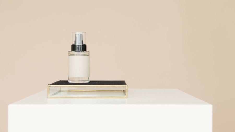 Minimal spray bottle on a white plinth