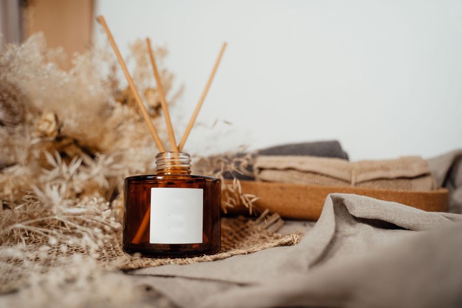 Amber reed diffuser bottle with dried flowers