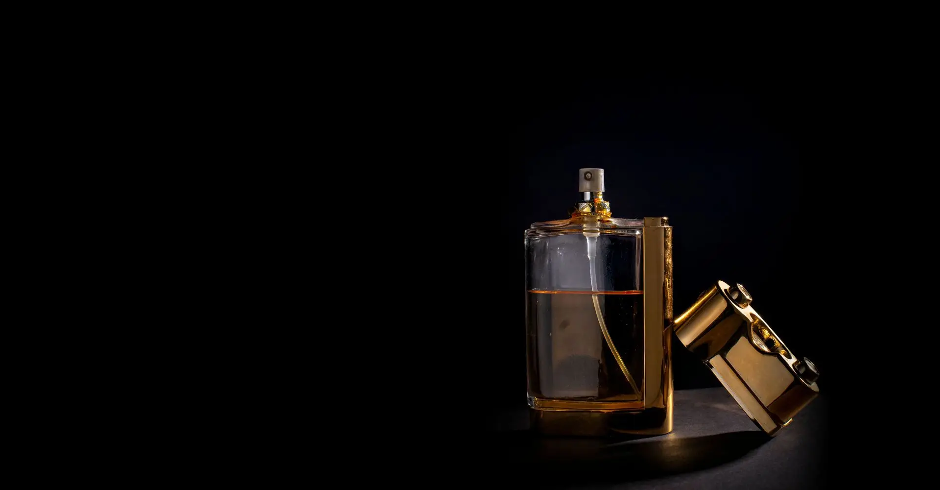 Amber glass perfume bottle with a sculpted gold overcap